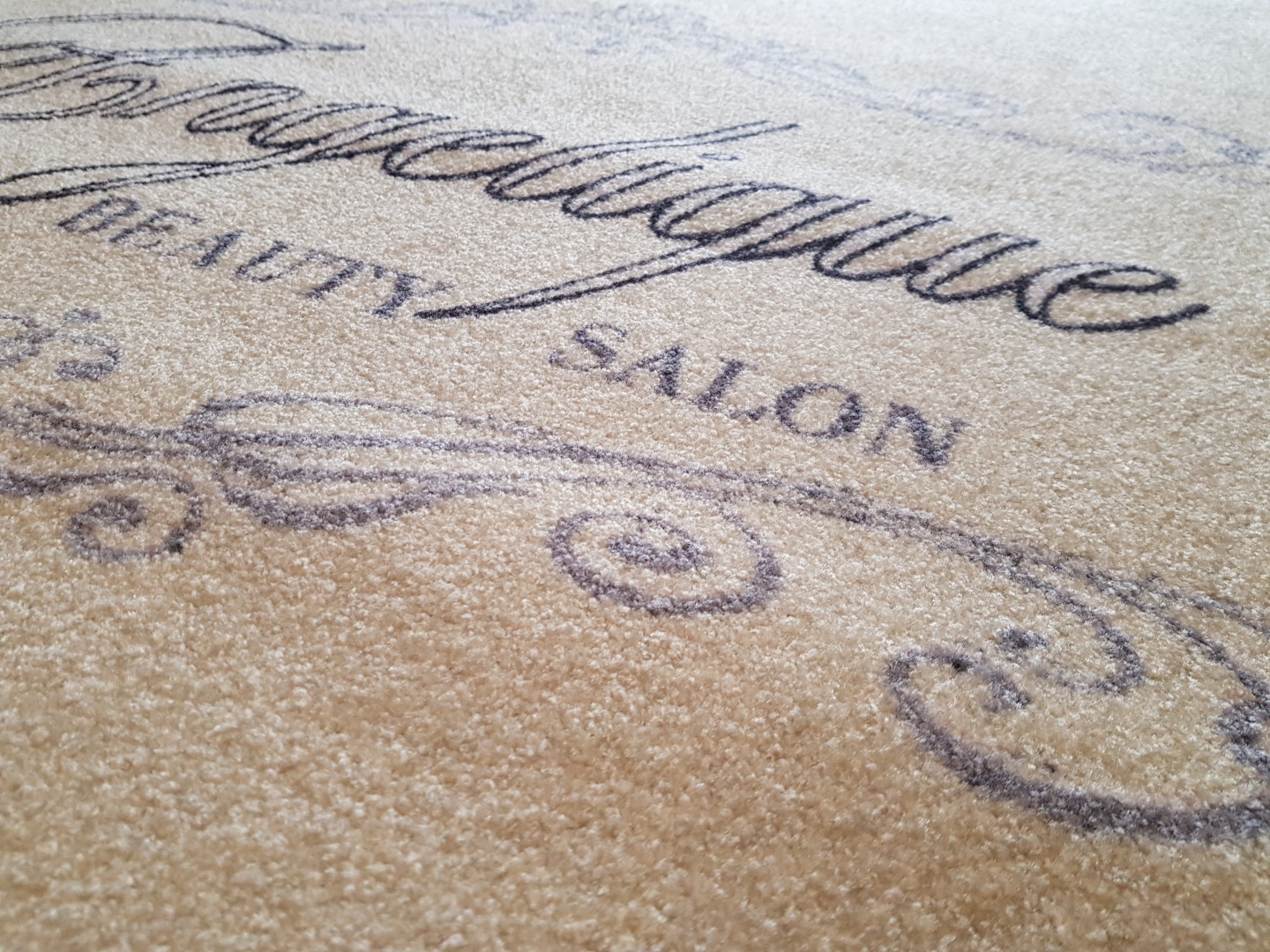 Detail einer hellen bedruckten Fußmatte mit Schriftzug
