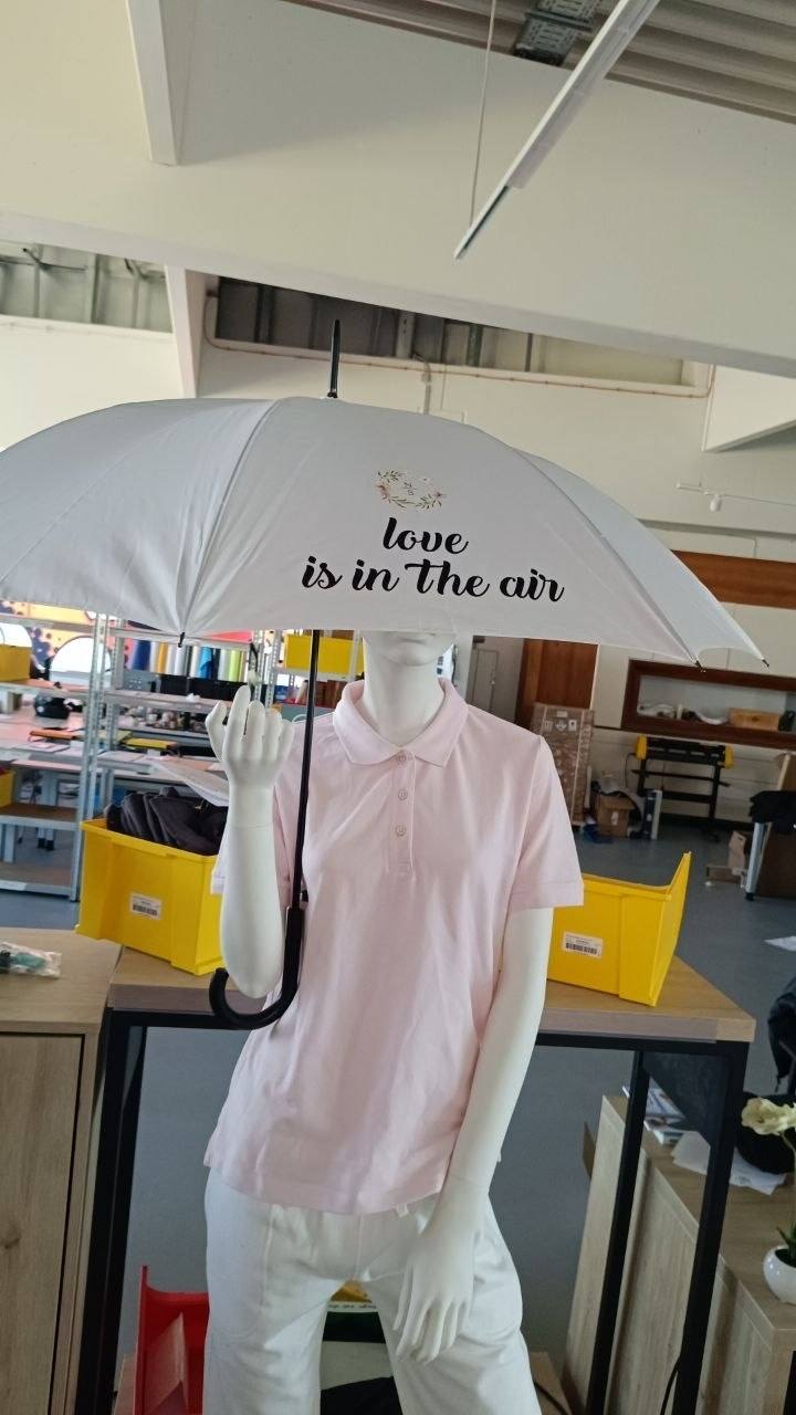 Weisser Hochzeitsschirm mit love is in the air Druck ueber Schaufensterpuppe, Wien